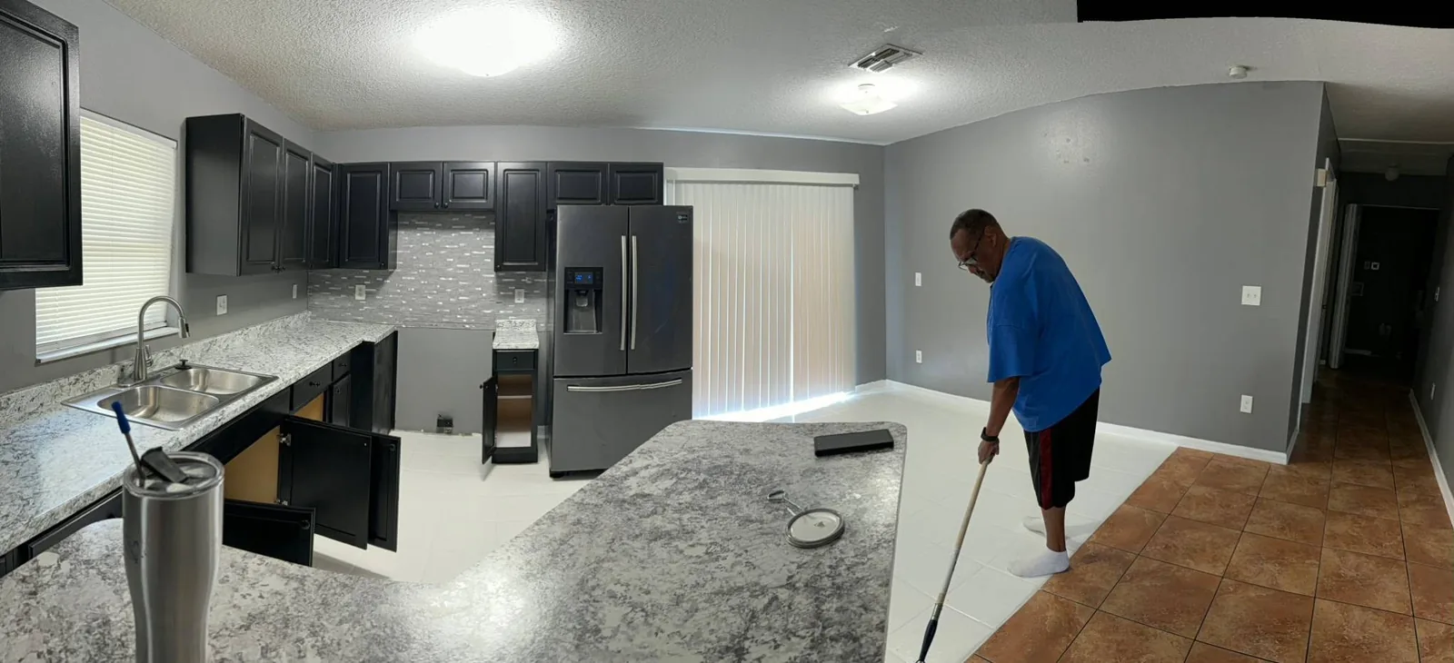 A Faithful Cleaning Service crew member mopping the freshly painted floor during the final clean of a Tampa property rehabilitation