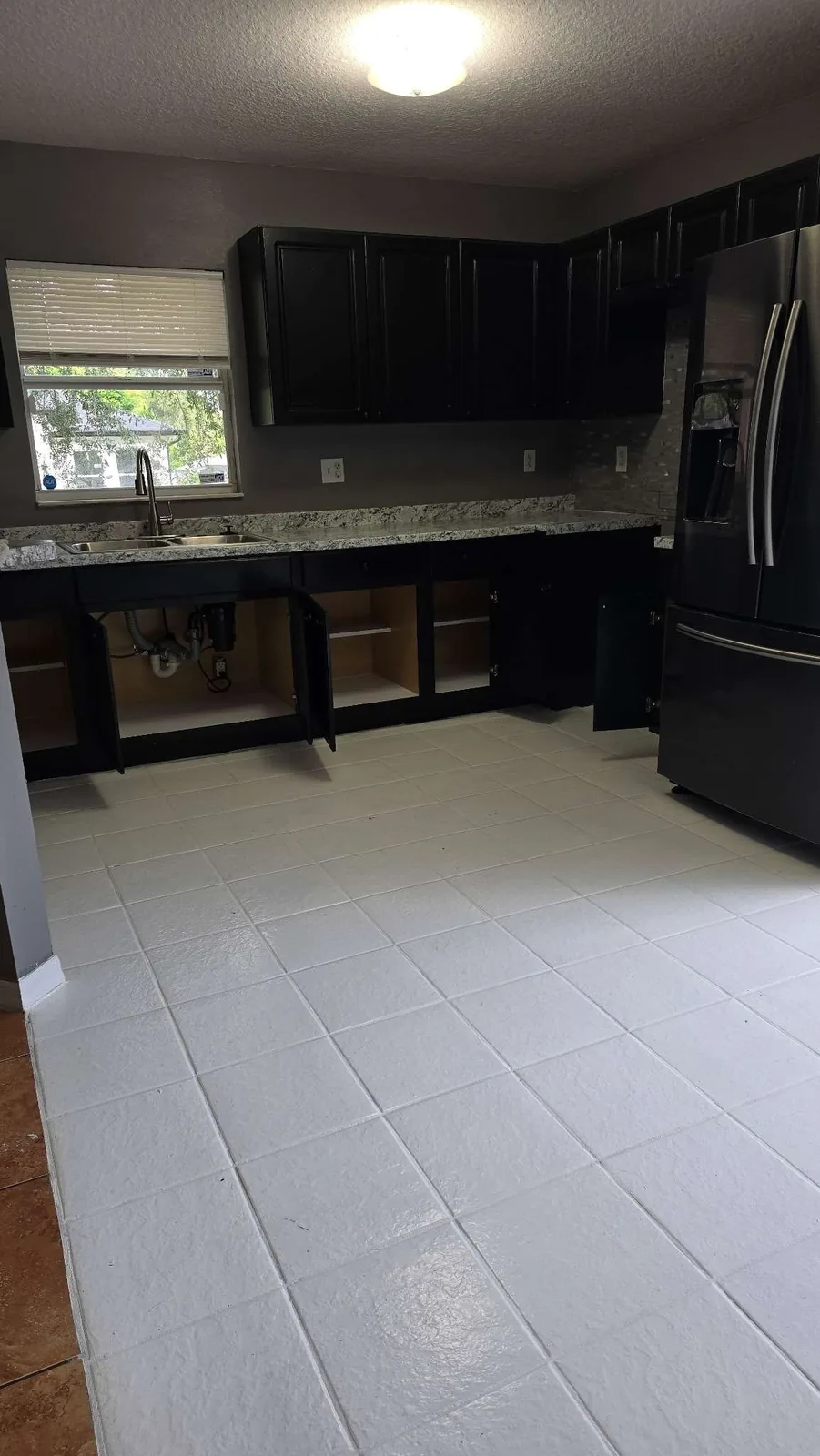 The finished kitchen with a glossy refinished floor, deep cleaned and move-in ready